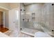 Modern bathroom with a large glass shower featuring a niche and brushed bronze fixtures at 8046 Lucky Creek Ln, Denver, NC 28037