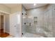 Modern bathroom with a glass-enclosed shower and tiled walls at 8046 Lucky Creek Ln, Denver, NC 28037