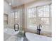 Spa-like bathroom with a glass-enclosed shower and soaking tub at 8046 Lucky Creek Ln, Denver, NC 28037