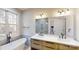 Modern bathroom featuring a soaking tub, double vanity, and large mirror at 8046 Lucky Creek Ln, Denver, NC 28037