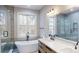 Luxurious bathroom featuring a soaking tub, walk-in shower, and modern vanity at 8046 Lucky Creek Ln, Denver, NC 28037