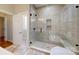 Modern bathroom with a large glass shower featuring a niche and brushed bronze fixtures at 8046 Lucky Creek Ln, Denver, NC 28037