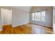 Spacious bedroom with hardwood floors and a large window providing natural light at 8046 Lucky Creek Ln, Denver, NC 28037