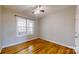 Cozy bedroom with a ceiling fan, hardwood floors, and natural light at 8046 Lucky Creek Ln, Denver, NC 28037