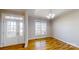 Elegant dining room featuring hardwood floors, natural light, and stylish lighting fixture at 8046 Lucky Creek Ln, Denver, NC 28037