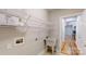 Functional laundry room with sink, shelving, and ample storage space at 8046 Lucky Creek Ln, Denver, NC 28037