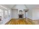 Bright living room featuring a stone fireplace, hardwood floors, and access to the outdoor deck at 8046 Lucky Creek Ln, Denver, NC 28037