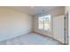 Bright bedroom with neutral walls, carpet, and a window offering natural light at 9601 Pointer Rd # 77, Huntersville, NC 28078