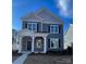 Two-story house with gray siding, stone accents, and a covered porch at 9601 Pointer Rd # 77, Huntersville, NC 28078