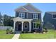 Charming two-story home with stone accents, dark shutters, and a well-manicured front yard at 9601 Pointer Rd # 77, Huntersville, NC 28078