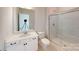 Bathroom with white vanity, walk-in shower, and marble-look tile at 9605 Pointer Rd # 78, Huntersville, NC 28078