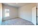 Spacious bedroom with a window and neutral wall colors at 9605 Pointer Rd # 78, Huntersville, NC 28078