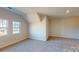 Large bonus room featuring two bright windows and plush carpeting at 9605 Pointer Rd # 78, Huntersville, NC 28078