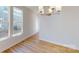 Well lit dining space featuring hardwood floors, large windows and a modern chandelier at 9605 Pointer Rd # 78, Huntersville, NC 28078