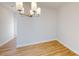 Open dining area with hardwood floors, a stylish chandelier, and neutral walls at 9605 Pointer Rd # 78, Huntersville, NC 28078