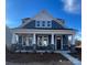 Craftsman style home with gray siding, stone accents, and a front porch at 9605 Pointer Rd # 78, Huntersville, NC 28078