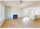 Bright living room with a fireplace, wood floors, and an open layout at 9605 Pointer Rd # 78, Huntersville, NC 28078