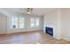Cozy living area with a fireplace, large windows, and beautiful wood flooring at 9605 Pointer Rd # 78, Huntersville, NC 28078