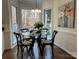 Charming breakfast nook with a glass table, seating for four, and bright windows overlooking the yard at 9709 Calpher Ct, Matthews, NC 28105