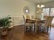 Traditional dining room with wood floors, a modern chandelier, and lots of natural light at 9709 Calpher Ct, Matthews, NC 28105