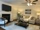 Inviting living room with a fireplace, ceiling fan, comfortable seating, and stylish decor at 9709 Calpher Ct, Matthews, NC 28105