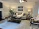 Bright living room with fireplace, ceiling fan, comfortable seating, and neutral decor at 9709 Calpher Ct, Matthews, NC 28105