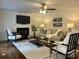 Living room featuring a fireplace, ceiling fan, comfortable seating, and tasteful decor at 9709 Calpher Ct, Matthews, NC 28105