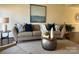 Cozy living room with stylish sofa, blue accent pillows, and neutral color palette creating an inviting atmosphere at 9709 Calpher Ct, Matthews, NC 28105