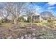 Inviting backyard featuring beautiful landscaping, mature trees, and an attractive deck at 10302 Sawtimber Ct, Huntersville, NC 28078