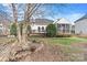 Well-maintained backyard with mature trees, landscaping, and a charming deck at 10302 Sawtimber Ct, Huntersville, NC 28078