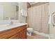 Bathroom includes a vanity, toilet, mirror and shower with tile surround at 10302 Sawtimber Ct, Huntersville, NC 28078