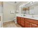 Bathroom featuring double sinks, a walk-in shower, and tile floors at 10302 Sawtimber Ct, Huntersville, NC 28078