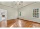 Bright bedroom with hardwood floors, tray ceilings, and natural light at 10302 Sawtimber Ct, Huntersville, NC 28078