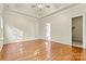 Spacious bedroom featuring hardwood floors, high ceilings, and walk-in closet at 10302 Sawtimber Ct, Huntersville, NC 28078