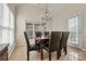 Well lit dining room with a window view, a chandelier, and a tile floor at 10302 Sawtimber Ct, Huntersville, NC 28078