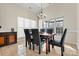 Inviting dining room with tile floors, a modern chandelier, and windows at 10302 Sawtimber Ct, Huntersville, NC 28078