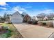 Attractive home featuring a well-maintained lawn and brick accents, attached garage and spacious driveway at 10302 Sawtimber Ct, Huntersville, NC 28078