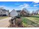 Charming home with a manicured lawn, mature shrubs, and a lovely brick facade and attached garage at 10302 Sawtimber Ct, Huntersville, NC 28078