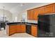 Bright kitchen featuring wooden cabinets, black countertops, and tile floors at 10302 Sawtimber Ct, Huntersville, NC 28078