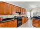 Kitchen featuring wood cabinets, black appliances and granite countertops at 10302 Sawtimber Ct, Huntersville, NC 28078