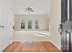 Bright living room featuring hardwood floors, a ceiling fan, and multiple windows at 10302 Sawtimber Ct, Huntersville, NC 28078