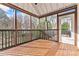 Beautiful screened-in porch with wood flooring, a ceiling fan, and views of the backyard at 10302 Sawtimber Ct, Huntersville, NC 28078