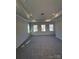 Spacious primary bedroom with carpeted floors and multiple windows at 11112 Lochmere Rd, Charlotte, NC 28278