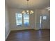 Dining room featuring hardwood floors, chandelier, and wainscoting at 11112 Lochmere Rd, Charlotte, NC 28278