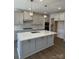 Modern kitchen with gray cabinets, large island, and stainless steel appliances at 11112 Lochmere Rd, Charlotte, NC 28278