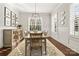 Bright dining room with a wood table, picture frames, and wainscoting at 1117 Churchill Commons Dr, Charlotte, NC 28211