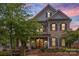 Two-story brick home with a charming front porch and landscaping at 1117 Churchill Commons Dr, Charlotte, NC 28211