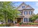 Gray and brick two-story home with black shutters and a welcoming front porch at 1117 Churchill Commons Dr, Charlotte, NC 28211