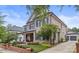 Brick two-story home with dark shutters, a front porch, and a landscaped yard at 1117 Churchill Commons Dr, Charlotte, NC 28211