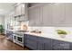 Modern kitchen with gray cabinetry, white countertops, and stainless steel appliances at 1117 Churchill Commons Dr, Charlotte, NC 28211